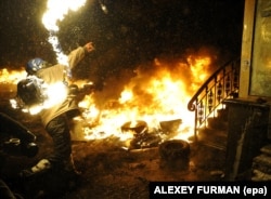 A protester throws a Molotov cocktail during an antigovernment protest on January 22.