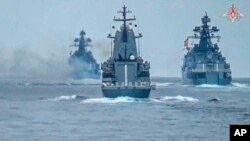 In this photo released by Russian Defense Ministry on July 21, Russian warships take part in naval drills in the Black Sea.