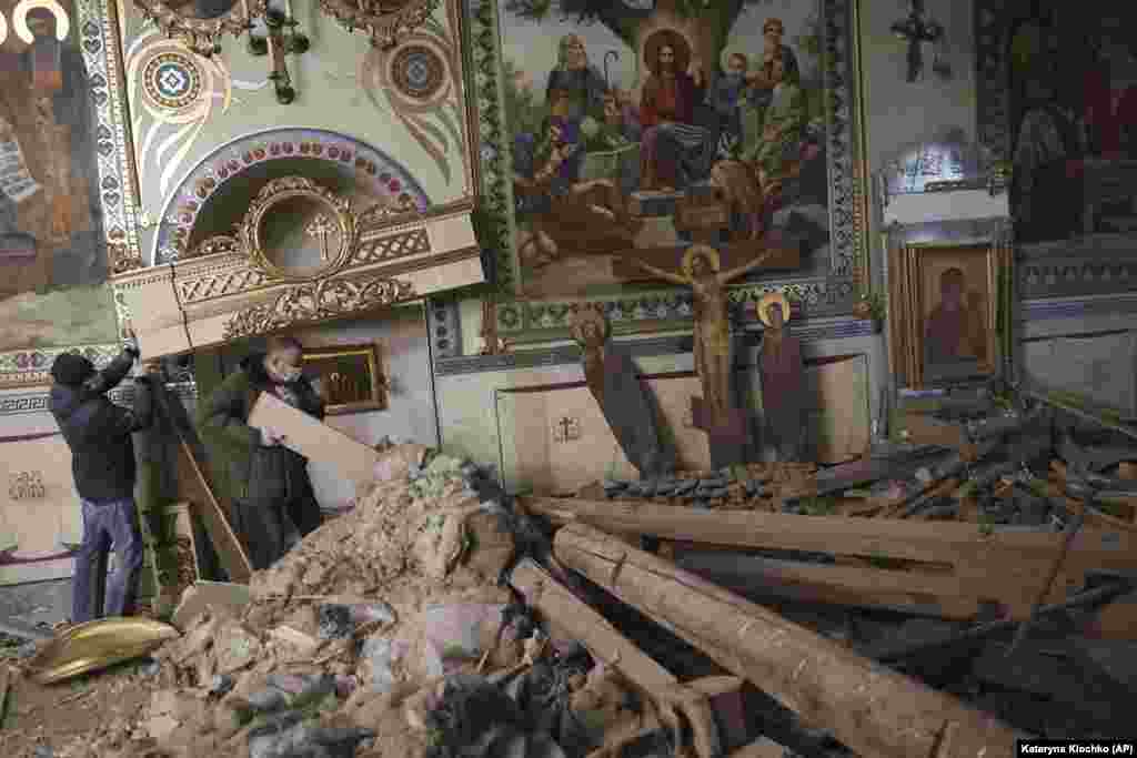 People clear the rubble inside St. Andrew&#39;s Cathedral ,which was damaged by a Russian strike on Zaporizhzhia, Ukraine.