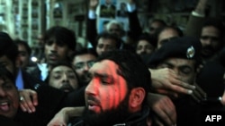 Arrested Pakistani bodyguard Malik Mumtaz Hussain Qadri leaves the court in Islamabad on January 5