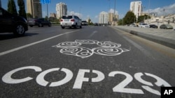 A mural painted on a highway welcomes visitors ahead of the 29th UN Climate Change Conference in Baku, scheduled for November 11-22.