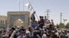 Taliban fighters hoisting the group’s flag in Kandahar, which was captured on August 12.