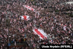 A sea of protesters waves red-and-white flags at an opposition rally in Minsk on August 23, 2020.