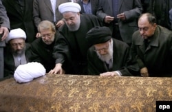 Iran's Supreme Leader Ayatollah Ali Khamenei (second from right) and Iranian President Hassan Rohani (center) pray on Rafsanjani's coffin before his funeral ceremony in Tehran on January 10.