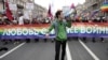 LGBT activists carry a banner reading "Love is stronger than war" during a May Day demonstration in St. Petersburg in 2014.