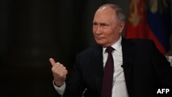 Russian President Vladimir Putin gestures during an interview with Tucker Carlson at the Kremlin on February 6.