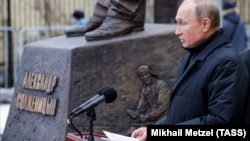 Russian President Vladimir Putin speaks during a ceremony to unveil a monument to Soviet-era dissident and writer Aleksandr Solzhenitsyn in Moscow. 