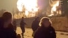 People run from an explosion during what the governor of Russia's Ryazan region southeast of Moscow described as an air attack on January 24.