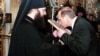 Vladimir Putin, president-elect at the time, kisses an icon at the Kyiv-Pechersk Lavra monastery, an Eastern Orthodox hub, in Kyiv in 2000. Mikhail Zygar says control of the Ukrainian capital holds an almost "mystical" allure for Putin. 