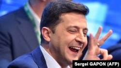 Volodymyr Zelensky reacts after the announcement of the first exit poll results in the second round of Ukraine's presidential election at his campaign headquarters. 