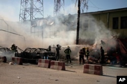 Firefighters work at the site of a deadly suicide attack in Jalalabad in 2018. A suicide bomber targeted a group of Sikhs and Hindus, killing at least 19 people.