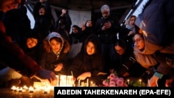 Iranians light candles for victims of Ukraine International Airlines Flight 752 during a protest in front of Amir Kabir University in Tehran on January 11.