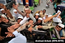 People receive free food during the fasting month of Ramadan in Peshawar on April 29.