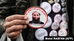 A man sells stickers with a picture of Taliban supreme leader Mullah Haibatullah Akhundzada at a market in Kabul. (file photo)