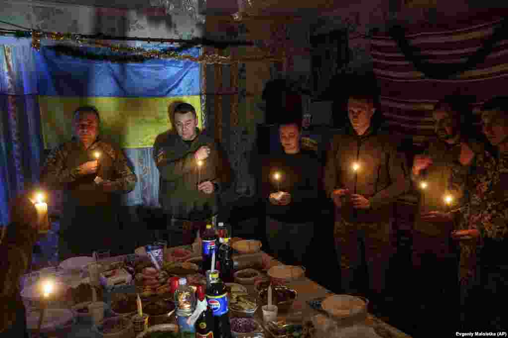 Ukrainian soldiers of 117th Separate Heavy Mechanized Brigade pray before a Christmas dinner near Pokrovsk, Donetsk region, Ukraine.