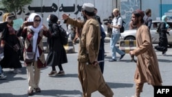 Taliban fighters dispersing Afghan women protesting in Kabul in August 2022