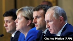 Ukrainian President Volodymyr Zelenskiy, (left to right) German Chancellor Angela Merkel, French President Emmanuel Macron, and Russian President Vladimir Putin attend a press conference after a summit on Ukraine at the Elysee Palace in Paris in December 2019.