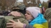 A Kherson resident embraces a Ukrainian soldier after the city's liberation on November 12.