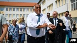 Former Bulgarian Prime Minister Boyko Borisov leaves a polling station after casting his ballot during the snap parliamentary and European Parliament elections at a polling station in Sofia on June 9.