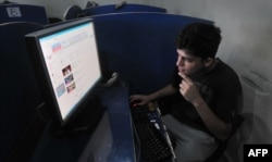 A young man browses YouTube at an Internet cafe in the eastern Pakistani city of Lahore. (file photo)