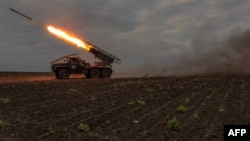 A Ukrainian multiple rocket launcher fires toward Russian positions, in the Kharkiv region.