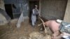 An Afghan man removes debris from his house following heavy rains and flash flooding in Kandahar on April 14.