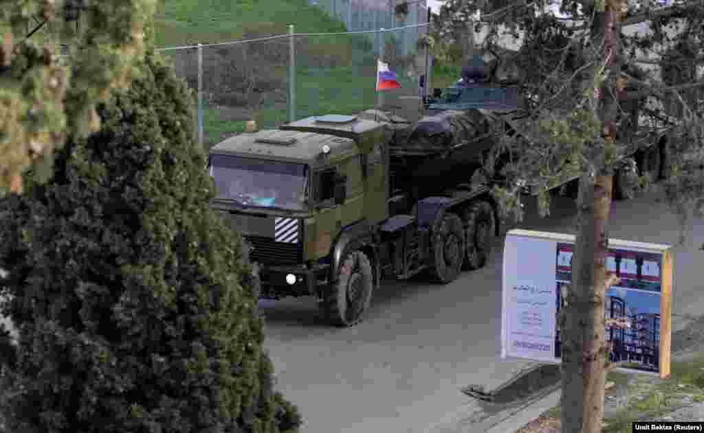 A Russian military vehicle nears an entrance to the Hmeimim air base in western Syria on December 15.&nbsp; This photo is one of several recent images around the Russian base taken by Umit Bektas, a Turkish photojournalist working for Reuters who spoke to RFE/RL about the situation around the military facility.&nbsp;