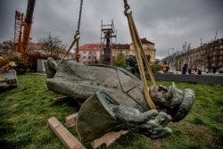 The monument to Soviet-era World War II Marshal Ivan Konev lies on the ground after it was removed from its pedestal in Prague on April 3.