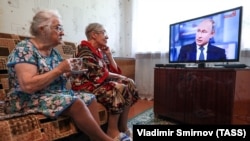 Elderly women watch a live broadcast of Russian President Vladimir Putin's annual question-and-answer session in the village of Yelna, Ivanovo region, on June 7.