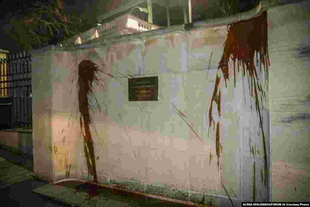 The wall outside the Russian Embassy in Prague was sprayed with ketchup overnight on April 18 during a protest staged to call attention to the deaths of the two people in the 2014 explosion. Moscow warned about its response to the expulsions.&nbsp;&quot;Prague is well aware of what comes after such hocus-pocus,&quot; Foreign Ministry spokeswoman Maria Zakharova said.