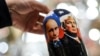 A vendor shows a traditional Russian wooden nesting doll depicting Vladimir Putin and Donald Trump at a gift shop in central Moscow. (file photo)