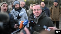 German Defense Minister Boris Pistorius speaks to reporters after laying flowers at a memorial on Maidan Nezalezhnosti, or Independence Square, in Kyiv on November 21.