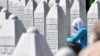 BOSNIA-HERZEGOVINA -- Bosnian Muslim woman, survivor of Srebrenica 1995 massacre, prays near graves of her relatives, at the memorial cemetery in Potocari, near Eastern-Bosnian town of Srebrenica, on July 11, 2019.