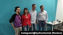 Russian opposition leader Aleksei Navalny (2nd right) poses for a picture with supporters in Tomsk on August 19.