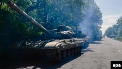 A column of pro-Russian militants with two Russian T-64 tanks and several APCs stand outside of Horlivka in Ukraine's Donetsk region on June 20.