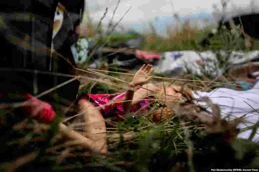 A child&#39;s doll is seen among the victims&#39; belongings scattered near the village of Grabovo.