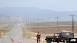 Turkish soldiers guard a road at Dogu Kapi, on the Turkish-Armenian border, on April 15.