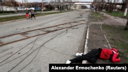 The body of a civilian lies in the street in the southern port city of Mariupol. Four Russian filtration camps are reportedly operating in the city.