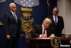 U.S. President Donald Trump signs the executive order titled Protecting The Nation From Foreign Terrorist Entry Into The United States on January 27.