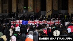 Protesters rally in front of parliament in Tbilisi on December 5, the eighth consecutive day of mass demonstrations against the government's postponement of EU accession talks until 2028.