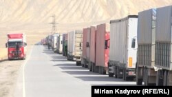 Kyrgyz truck drivers wait in line to ferry goods across the Torugart border crossing with China.