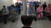 Students attend a class bifurcated by a curtain separating males and females at a private university in Kabul on September 7 to follow the Taliban's ruling. 