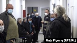 People in Leposavic wait in line to get the Pfizer vaccine on December 26. 