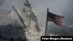 An American flag flies near the base of the destroyed World Trade
Center in New York, one of the targets of the September 11, 2001 terrorist attacks. 