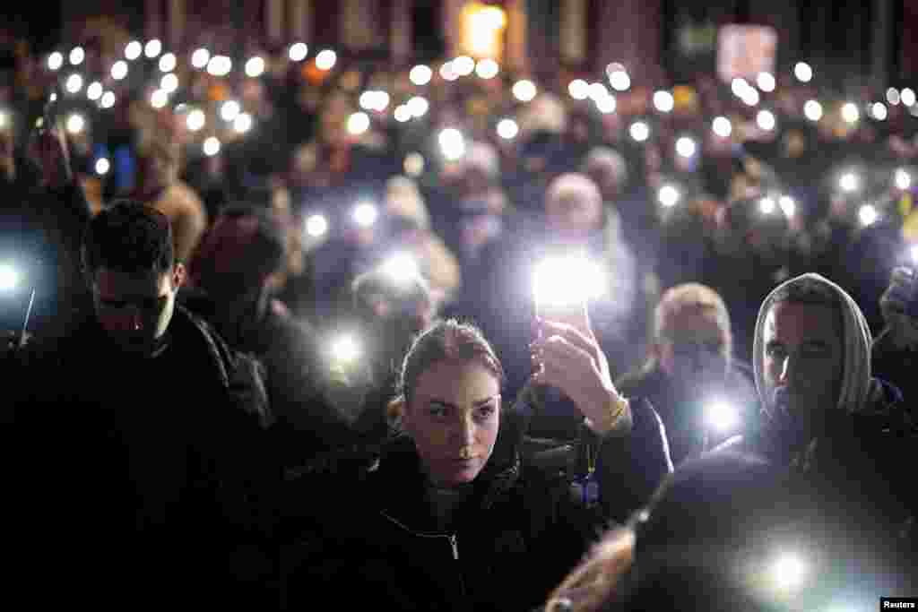  Demonstrators flash mobile phone lights during a protest against government policies, corruption, and negligence, which they blame for the deaths of the victims in the November 2024 Novi Sad railway station disaster, in Belgrade on January 24. &nbsp; 