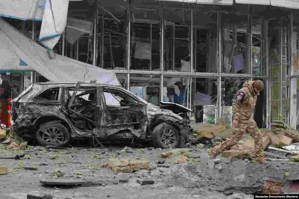 An investigator walks near a damaged store after shelling in the occupied city of Donetsk which local Russian-installed authorities called a Ukrainian military strike on January 10.