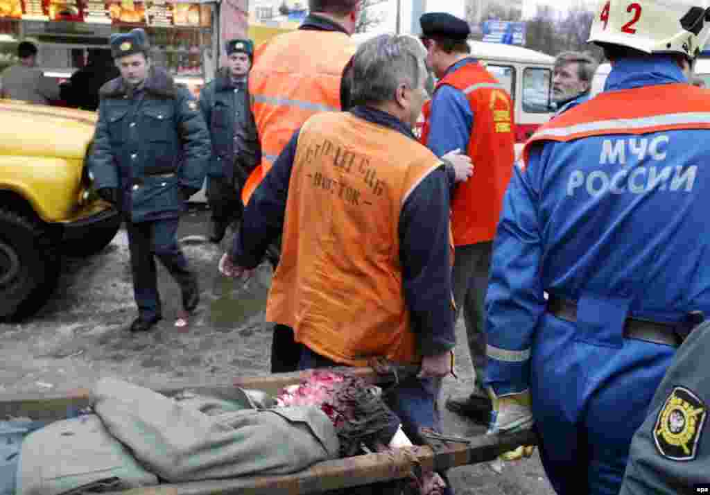 Rescue workers carry a wounded person.