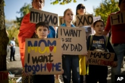 Ukrainian children hold banners during a protest outside the Russian Embassy in Bucharest on October 14.