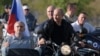 Russian President Vladimir Putin (center) with the Kremlin-linked bikers club Night Wolves, which has been targeted in the latest round of EU sanctions against Russia. (file photo)