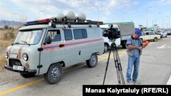 Journalists close to the site of where an explosion occurred in Kazakhstan's Baizak district on August 27.